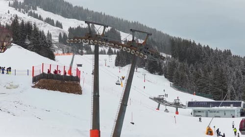 Ski Lift Gondola Transporting Skiers Up Snowy Mountain Slope at Winter Resort in the Alps for Fun