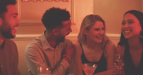 Four Friends Celebrate at Bar With Drinks