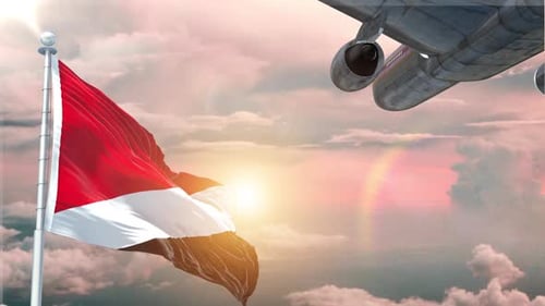 Passenger Airplane Flying Past Waving Flag at Golden Sunset