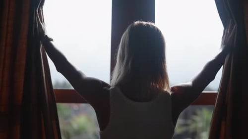 Enjoy Early Morning Woman Opening Curtains in Bedroom Back View Traveling Female Tourist Admiring