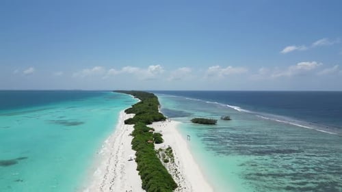 Aerial above Long lush sanbar amid vast blue lagoon on Dhigurah island, Maldives