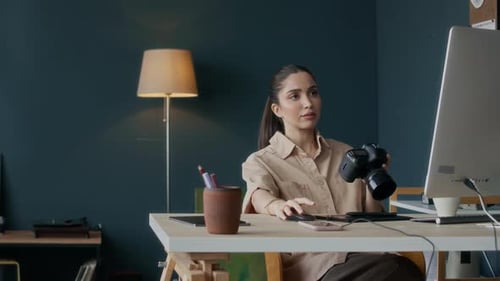 Woman Reviews Photos in her Corporate Office