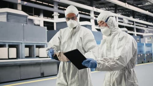 Engineering Team Brainstorming in Microchip Factory Cleanroom Using Devices