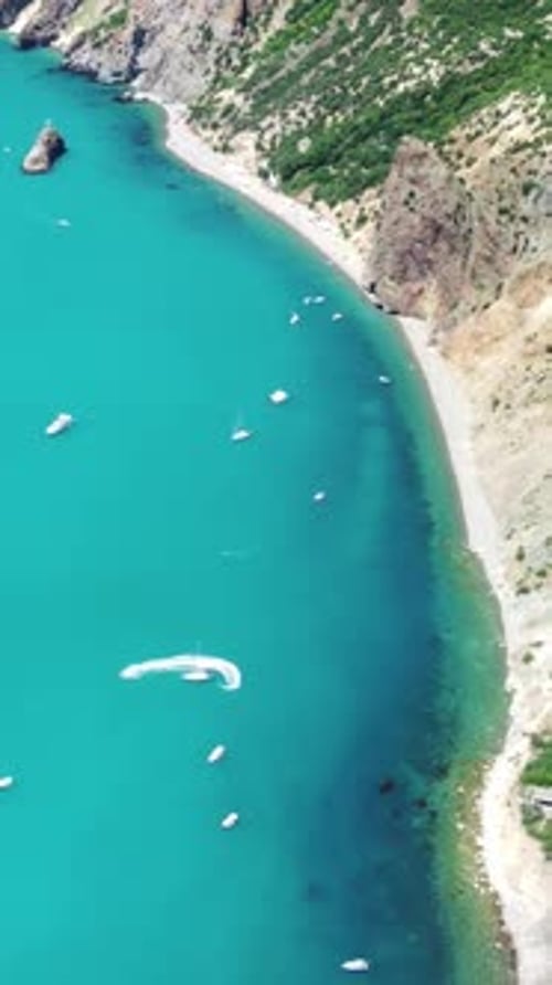 Aerial Vertical View of Seascape with Crystal Clear Azure Sea and Rocky Shores Yachts in a Beautiful