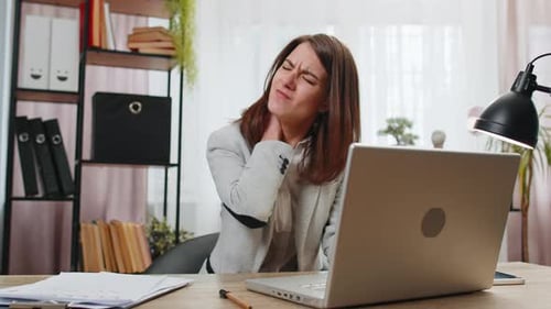 Businesswoman Suffers From Spine Neck Muscle Pain at Home Office Working on Laptop Overworking