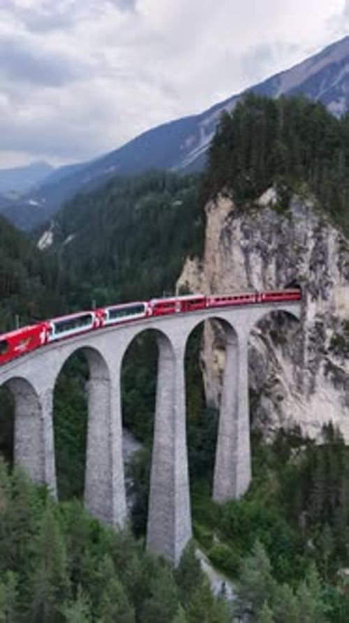 Famous Red Train Crossing the Landwasser Viaduct in the Swiss Alps