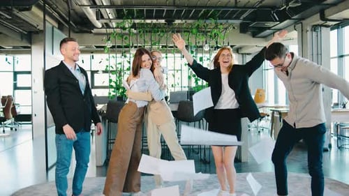Enthusiastic Team Throws Paper After Successful Project