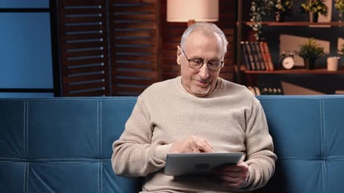 Senior Man Relaxing at Home With Tablet
