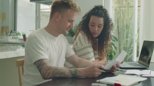 Couple Reviewing Finances Together at Home
