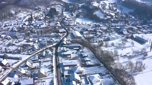 Landscape Of Small Town Covered In White Snow During Winter - aerial drone shot