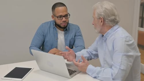 Angry Old Man Talking with Male Worker in Office
