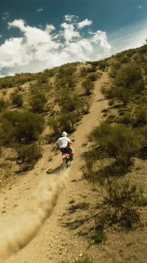 Motorbiker Rides Vehicle Leaving Dust Trail