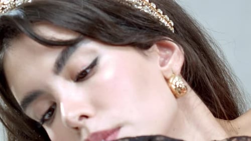 Glamorous Young Woman Lighting Birthday Candle