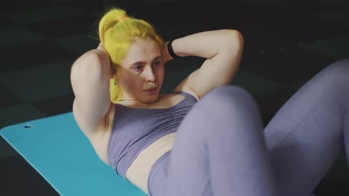 Gorgeous Female Professional Bodybuilder Doing Workout Exercises in Gym