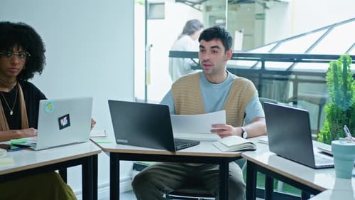 Engaged Young Adults Collaborating in Office Meeting