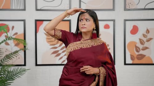 Woman in Saree Shielding Eyes and Looking