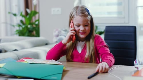 Girl Talking on Phone at Desk