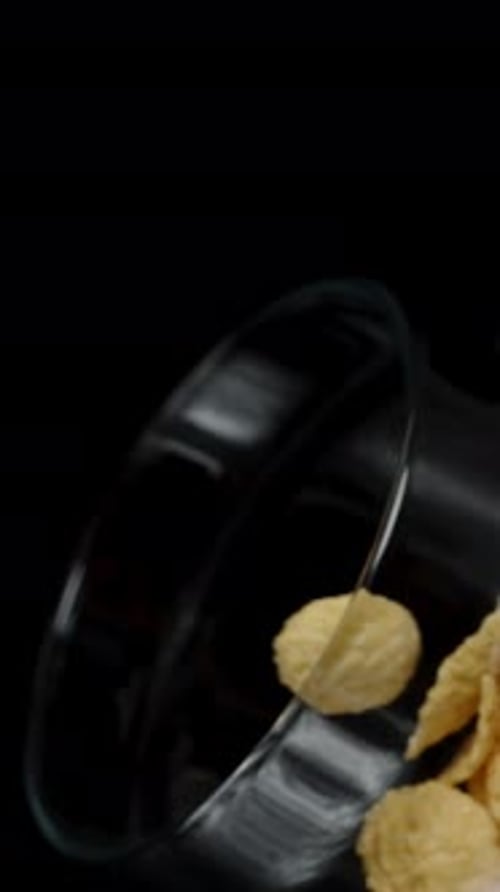 Cereal Flakes Pouring From a Bowl