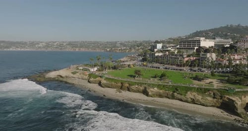 a beach with a body of water and buildings