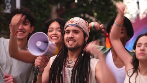 Activist speaking with megaphone at LGBT pride parade promoting equal rights