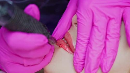Permanent makeup lips. Beautiful young woman gets lips correction procedure