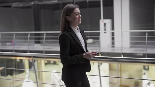 Successful Ambitious Young Woman Recruiter Walking in Workspace Office with Smartphone Perspective