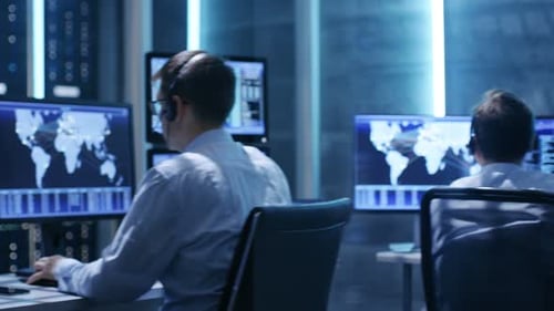 Panoramic Shot of Professionals Working in System Control Center Full of Displays with Various Data