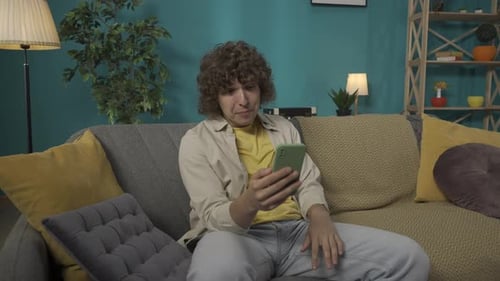 Enthusiastic Young Adult Enjoying Video Call at Home