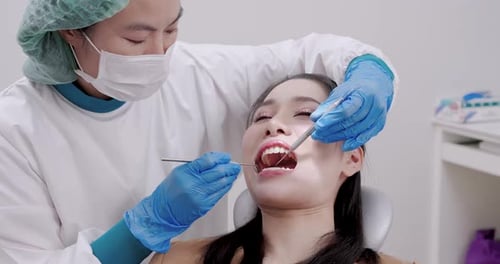 Woman Receiving Dental Exam at Dentist Office