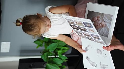 Child Looking Through Baby Photo Album