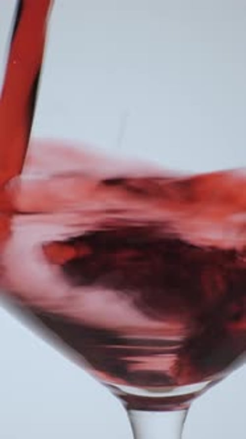 Wine Pouring in Wine Glass on White Background