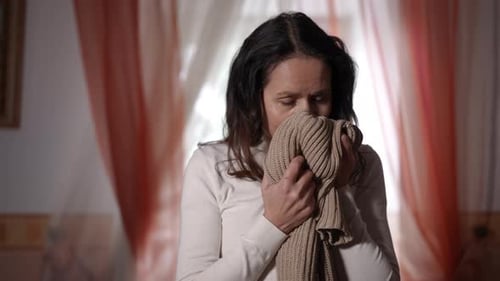 Woman Enjoys the Smell of Knit Sweater