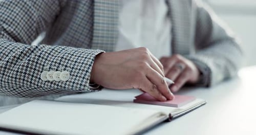 Hands, writing in a notebook and sticky notes with a business person in the office planning