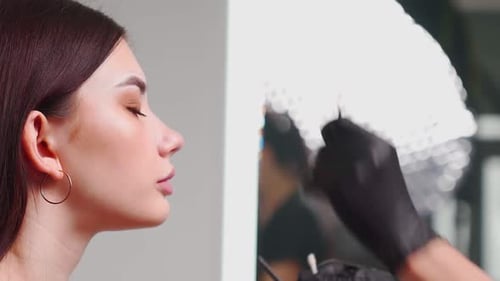 Permanent Makeup Master Prepares Woman Client for Eyebrow Microblading Procedure