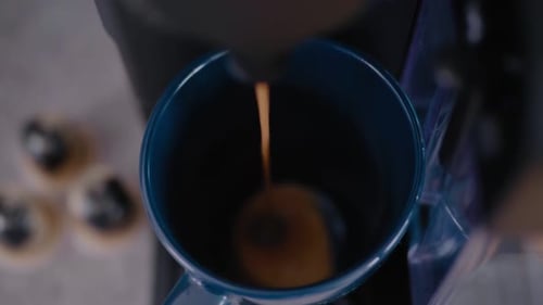 Coffee Machine Brewing Latte into Blue Ceramic Cup