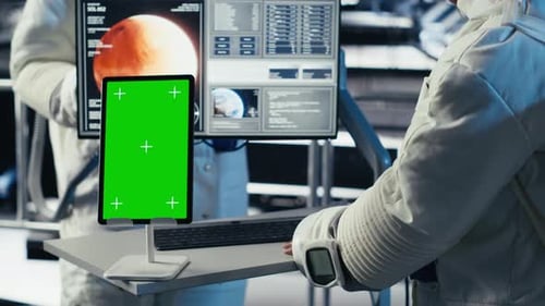 Astronauts Reviewing Onboard Analytics on Isolated Screen Tablet
