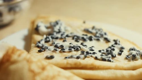 Delicious Crepes Topped with Cream and Black Caviar
