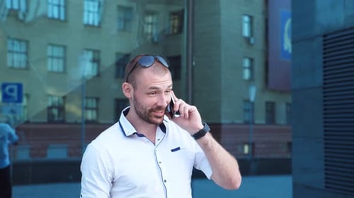 Young Adult Talking on Phone Outside