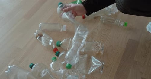 Hand Sorting Used Plastic Bottles for Recycling