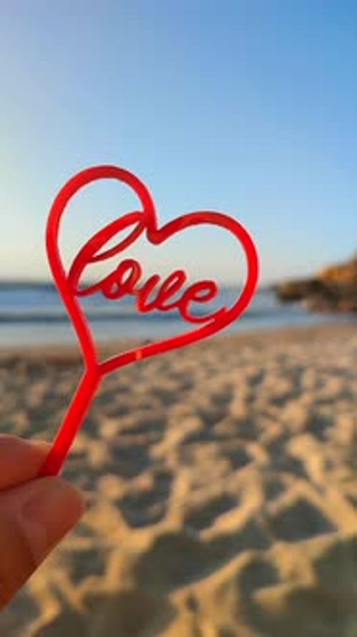 Person Holding Fingers Hand Shape Red Heart Word Love Background Sea Vertical