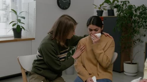 Woman Crying During Therapy Session, Supported by Friends