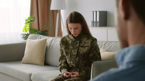 Woman in Camouflage Talking to Therapist Indoors