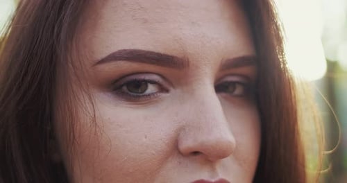 Close Up of Face of Beautiful Young Caucasian Woman Looking Straight to Camera Outdoor Eyes and
