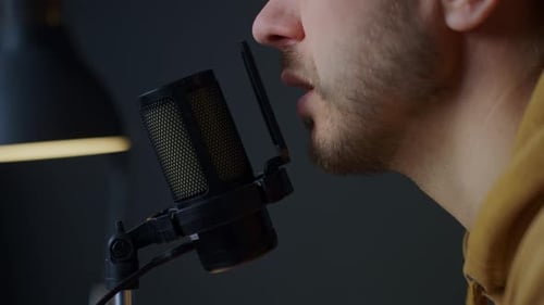 Adult Male Speaking Into a Microphone in Studio