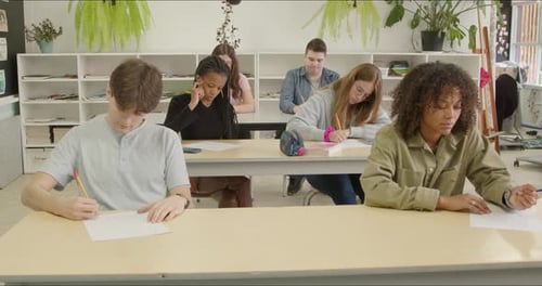 Focused Students Writing Essay Test Exam in School Class. Gen Z High School - College Alumni Scholar