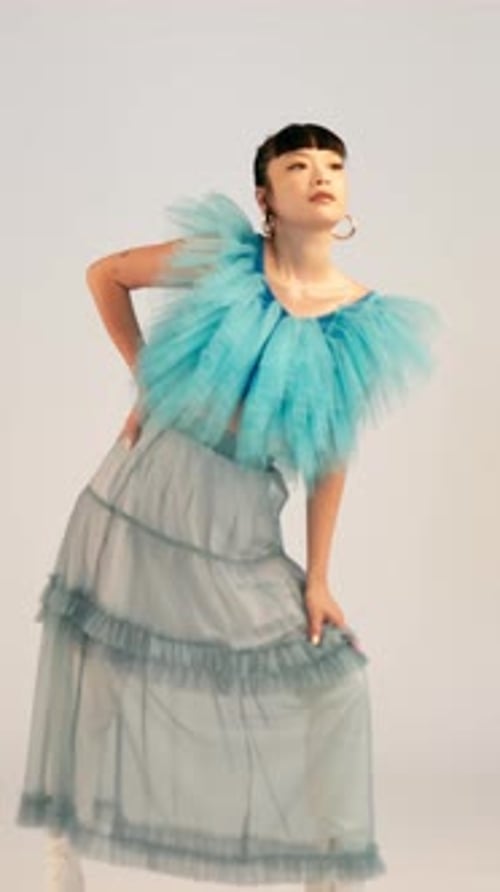 Fashion, woman and face of model in studio with trendy, cool and funky outfit with makeup