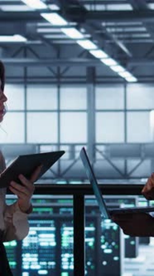 Vertical Video Data Scientists Performing Equipment Vulnerability Scans in Server Farm