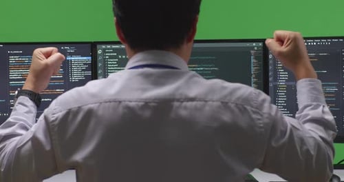Happy Developer Celebrating And Dancing While Write Code With Multiple Screens In Green Screen