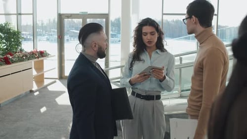 Colleagues Discussing Working Moments in Office Corridor