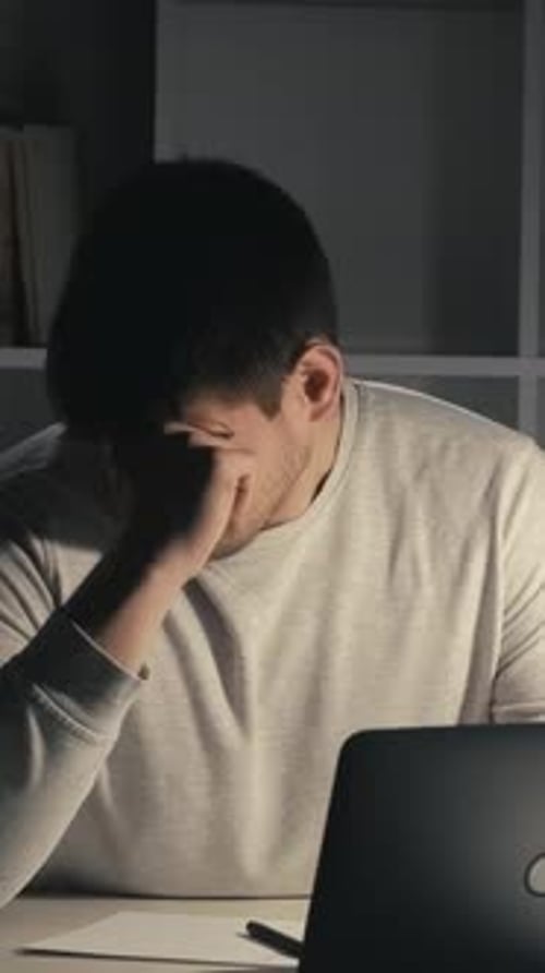Young Adult Working Late at Night on Laptop